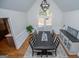 Spacious dining room featuring a rustic wood table, high ceiling, and a large window offering natural light at 2304 Larchmont Ct, Villa Rica, GA 30180