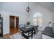 Elegant dining room with a high ceiling, large window, and a rustic wood table set for a meal at 2304 Larchmont Ct, Villa Rica, GA 30180