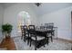 Elegant dining room featuring a high ceiling, large windows, and a rustic wood table for formal gatherings at 2304 Larchmont Ct, Villa Rica, GA 30180