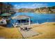 Scenic lake view featuring a covered boat dock with seating area, ideal for waterfront living at 2304 Larchmont Ct, Villa Rica, GA 30180