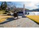 Lakeside dock with covered boat slip, outdoor seating, and clear blue water at 2304 Larchmont Ct, Villa Rica, GA 30180