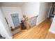 Inviting entryway with hardwood floors, wooden staircase, and a bright blue door, creating a warm welcome at 2304 Larchmont Ct, Villa Rica, GA 30180