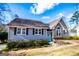Inviting home featuring gray siding, a charming blue door, and attractive landscaping details at 2304 Larchmont Ct, Villa Rica, GA 30180