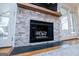 Close-up of stone fireplace with wooden mantel, perfect for cozy evenings at 2304 Larchmont Ct, Villa Rica, GA 30180