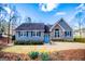 Charming home with stone accents, blue front door, and blossoming spring flowers in the front yard at 2304 Larchmont Ct, Villa Rica, GA 30180