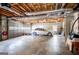 Spacious garage with exposed ceiling, concrete floors, and car parked inside at 2304 Larchmont Ct, Villa Rica, GA 30180