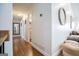 Bright hallway boasts hardwood floors, a round mirror, and access to other rooms in the home at 2304 Larchmont Ct, Villa Rica, GA 30180