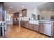 Bright kitchen featuring wood cabinets, stainless appliances, farmhouse sink, and hardwood floors throughout at 2304 Larchmont Ct, Villa Rica, GA 30180