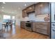Well-appointed kitchen with stainless steel appliances, wooden cabinetry, white subway tile, and a view of the dining area at 2304 Larchmont Ct, Villa Rica, GA 30180