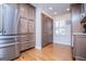 The kitchen area features wood cabinets, a stainless steel refrigerator, and wood floors with bright recessed lighting at 2304 Larchmont Ct, Villa Rica, GA 30180