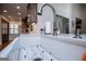 The kitchen features a white farmhouse sink, stylish faucet, white countertops, and mosaic tile backsplash at 2304 Larchmont Ct, Villa Rica, GA 30180