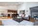 Open-concept living room with a modern sofa, area rug, coffee table, and view of the kitchen with a breakfast bar at 2304 Larchmont Ct, Villa Rica, GA 30180