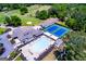 Aerial view of a community pool, tennis courts, and clubhouse with ample seating for residents at 2304 Larchmont Ct, Villa Rica, GA 30180