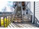 Wooden staircase leading from the deck to the backyard and lake at 2304 Larchmont Ct, Villa Rica, GA 30180