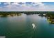 Breathtaking aerial of lake with boat leaving wake, showcasing waterfront homes and lush scenery at 2304 Larchmont Ct, Villa Rica, GA 30180