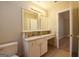 Bathroom featuring vanity, granite countertop, tile flooring, toilet, and doorway to another room at 626 N Fairfield Dr, Peachtree City, GA 30269