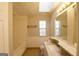 Bathroom showcases a vanity area with granite countertops, a skylight, and a bathtub with shower at 626 N Fairfield Dr, Peachtree City, GA 30269