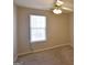 Bedroom featuring carpet flooring, a window offering natural light, and a ceiling fan at 626 N Fairfield Dr, Peachtree City, GA 30269