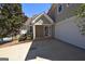 Side view of charming home featuring a two-car garage and a manicured front yard at 626 N Fairfield Dr, Peachtree City, GA 30269