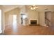 Open living room featuring hardwood floors, fireplace, and access to patio at 626 N Fairfield Dr, Peachtree City, GA 30269