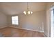 Bright living room with wood floors and stylish lighting fixtures, perfect for entertaining at 626 N Fairfield Dr, Peachtree City, GA 30269