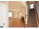 Open-concept living room featuring hardwood floors, fireplace, and staircase at 626 N Fairfield Dr, Peachtree City, GA 30269