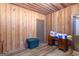 Partially finished basement with wood paneling, light-colored wood-look flooring, and an exterior door at 222 Providence Rd, Fayetteville, GA 30215