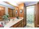 Bathroom with wooden cabinetry, large mirror, and neutral countertops at 222 Providence Rd, Fayetteville, GA 30215