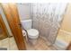 Bathroom showcasing a toilet, shower curtain and tile flooring at 222 Providence Rd, Fayetteville, GA 30215