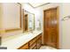 Bathroom featuring a long vanity with sink, wood cabinets and trim with a door at 222 Providence Rd, Fayetteville, GA 30215