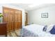 Well-lit bedroom with a bed, ample closet space, and wood-look floors for a cozy and inviting feel at 222 Providence Rd, Fayetteville, GA 30215