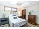 Comfortable bedroom featuring a metal frame bed, light-colored walls, wood-look flooring and stylish nightstands at 222 Providence Rd, Fayetteville, GA 30215
