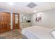 Bedroom with light gray walls, wood-look vinyl floors, and decorative closet doors at 222 Providence Rd, Fayetteville, GA 30215