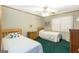 Bedroom with two beds, ceiling fan, hardwood trim, and carpet flooring at 222 Providence Rd, Fayetteville, GA 30215