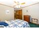This bedroom includes a ceiling fan, wood trim and a blue and white bedspread at 222 Providence Rd, Fayetteville, GA 30215