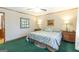 Bedroom showcasing a queen bed, soft green carpeting, and a ceiling fan at 222 Providence Rd, Fayetteville, GA 30215