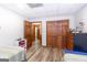 Bright bedroom with twin beds, featuring wood-look floors and a spacious closet with bi-fold doors at 222 Providence Rd, Fayetteville, GA 30215