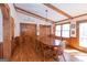 Bright dining room with hardwood floors, wood beams, and large windows at 222 Providence Rd, Fayetteville, GA 30215