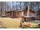 View of the exterior with brickwork, back patio and mature trees on a well-maintained lawn at 222 Providence Rd, Fayetteville, GA 30215