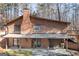 Two-story brick home featuring covered patio, and mature trees creating a private, serene setting at 222 Providence Rd, Fayetteville, GA 30215
