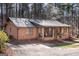 Quaint home with inviting front porch, rocking chairs and mature trees creating a private setting at 222 Providence Rd, Fayetteville, GA 30215