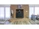 Elegant brick fireplace complemented by sheer curtains and decor, adding warmth and style to the living area at 222 Providence Rd, Fayetteville, GA 30215