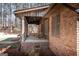 Brick home with covered porch offering rocking chairs and relaxing outdoor views at 222 Providence Rd, Fayetteville, GA 30215