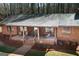 Charming brick home featuring a cozy front porch with rocking chairs and rustic wood accents at 222 Providence Rd, Fayetteville, GA 30215