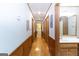 Hallway featuring wood wainscoting, hardwood floors, access to bathroom and laundry at 222 Providence Rd, Fayetteville, GA 30215