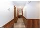 Hallway with wood-look vinyl floors and painted walls with wood trim and decorative touches at 222 Providence Rd, Fayetteville, GA 30215