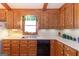 Traditional kitchen with wood cabinets, laminate countertops, and double bowl sink with window view at 222 Providence Rd, Fayetteville, GA 30215