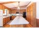 Kitchen with wood cabinets, large island, hardwood floors, and pendant lighting at 222 Providence Rd, Fayetteville, GA 30215