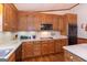 Classic wood kitchen with breakfast bar, laminate counters, and stainless microwave and oven at 222 Providence Rd, Fayetteville, GA 30215