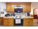 Classic kitchen design with warm wood cabinetry, updated appliances, and a comfortable layout for cooking and entertaining at 222 Providence Rd, Fayetteville, GA 30215